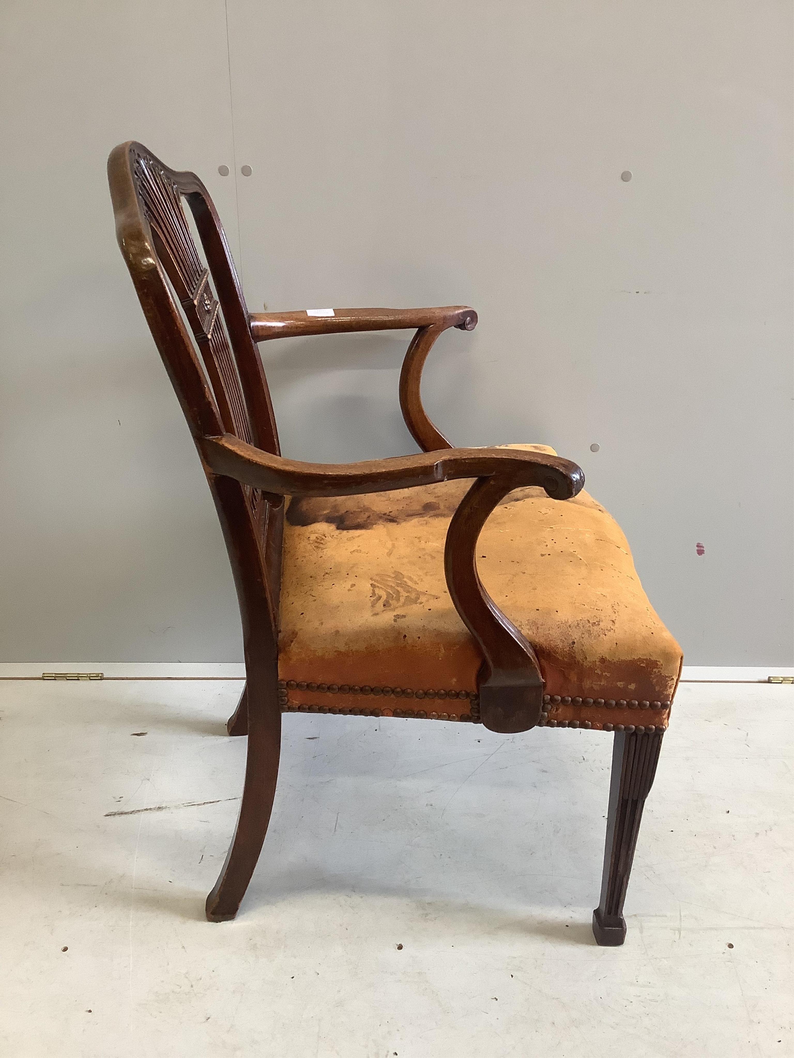 A George III mahogany elbow chair, stained leather seat, width 63cm, depth 49cm, height 95cm. Condition - fair